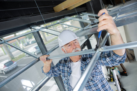 contractor erecting framework for suspended ceilingの写真素材