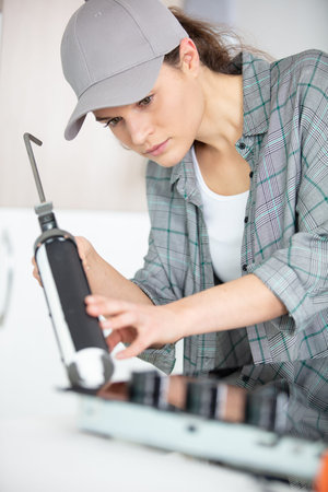 woman installing induction hobs in a kitchen
