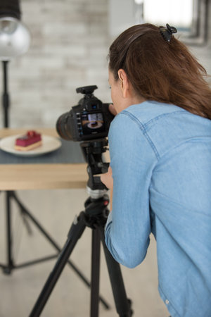 young happy woman photographing food