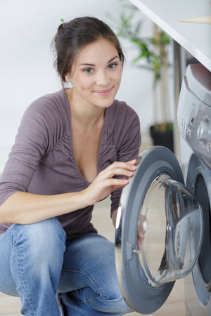 a woman doing a laudryの写真素材