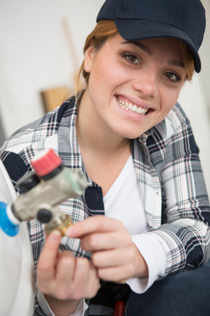happy and excited young plumber woman