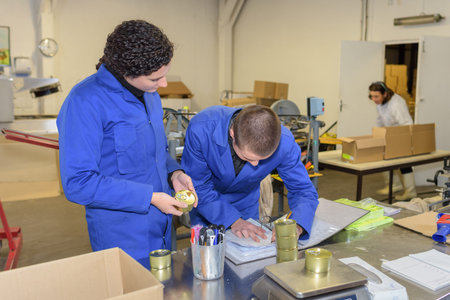 factory workers checking product weights on scales