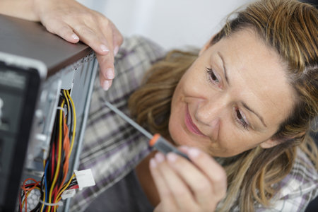 close view of female computer technician using a screwdriverの写真素材