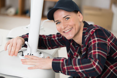 happy woman repairing a chairの写真素材