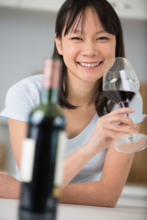 portrait of a brunette beauty drinking wineの写真素材
