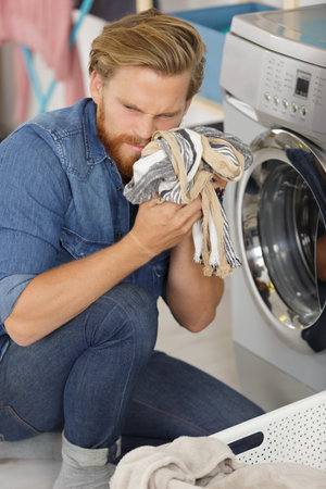 man doing laundryの写真素材
