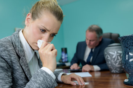 sad woman next to urnの写真素材