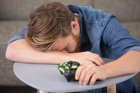 young man or gamer with gamepad failed in video gameの写真素材