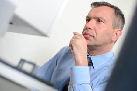Man focused on computer screenの写真素材