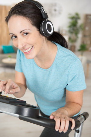 young woman exercising at home on stepper trainer