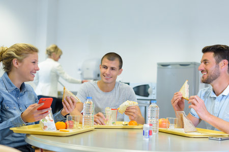 a friendly group of mates with sandwichesの写真素材