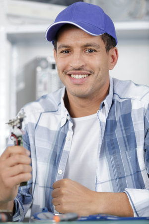 portrait of male technician holding electronic component