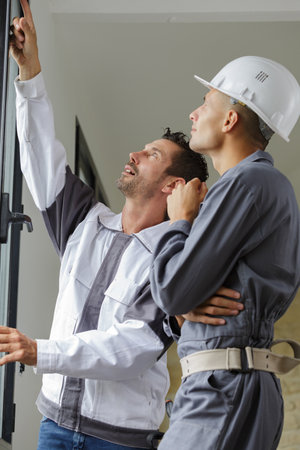 insulated door fitter pointing at the topの写真素材