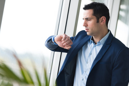 closeup businessman looks at his watchの写真素材