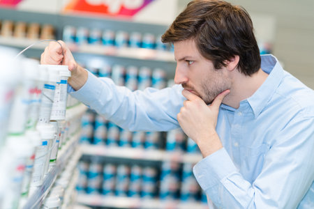 man choosing product in hardware storeの写真素材