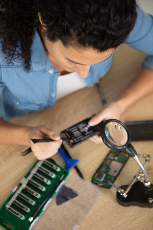 female repairing watch in her workshopの写真素材
