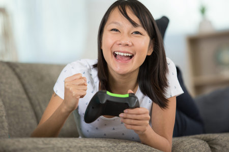happy woman playing video games holding controller