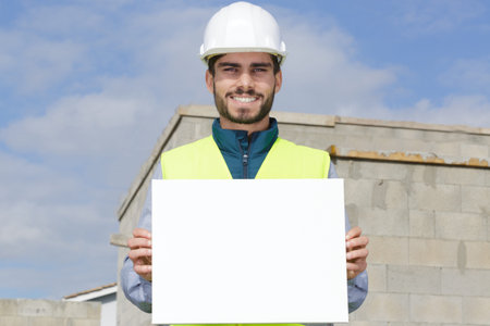 bearded man builder showing blank board