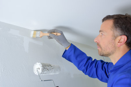 Decorator cutting in around ceilingの写真素材