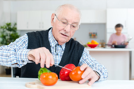 old man preparing the tomatoesの写真素材