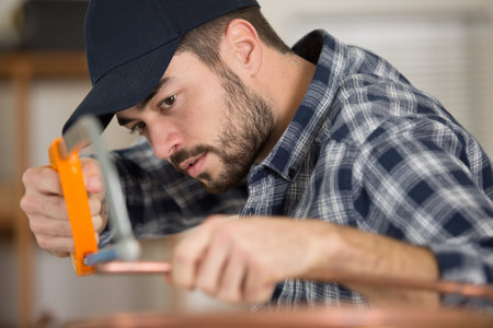 a cooper worler during pipes cutting