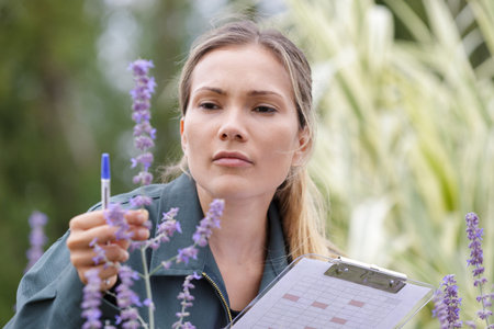a woman checking plants outdoors