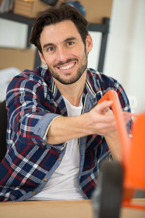 happy male worker smiling at the cameraの写真素材
