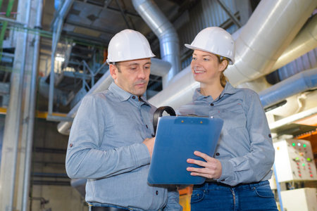 female and male engineer checking pipeline connections