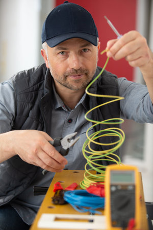 technician putting cables in workshop