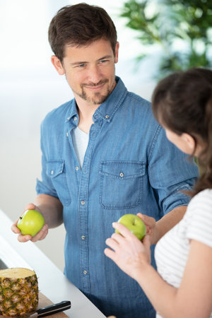 happy couple eating fresh fruitsの写真素材