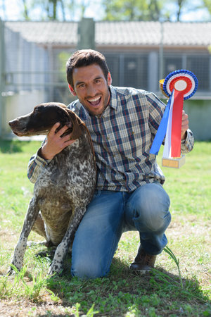 happy dog owner holding ribbon