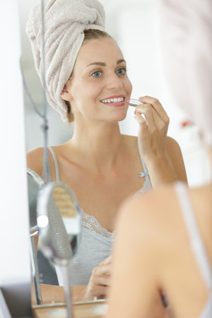 beautiful woman removing doing her make-upの写真素材