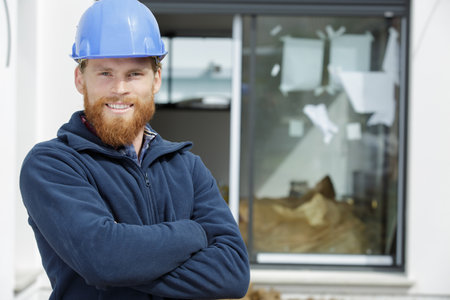 worker in working clothes with crossed armsの写真素材