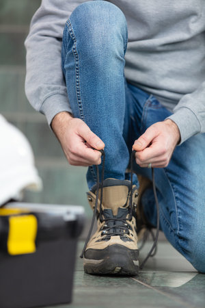 female worker doing her laces up