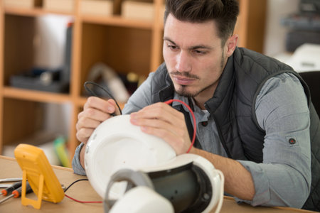 male technician using multimeter to test applianceの写真素材