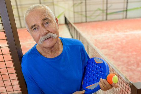 happy senior male tennis player after trainingの写真素材