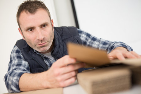 a man is sanding woodの写真素材