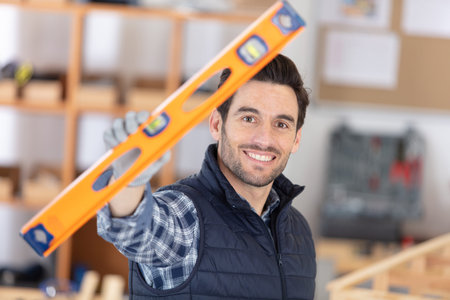 male worker shows spirit level