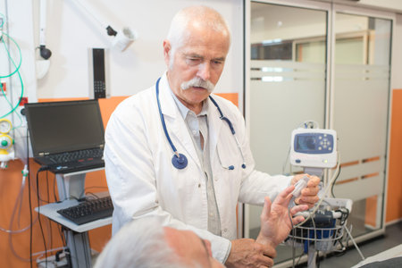 senior doctor putting pulse oximeter on patients hand