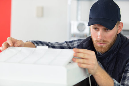 a repairman next to a washing machine