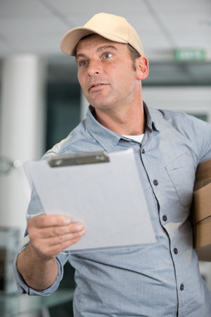man with clipboard working at a warehouse