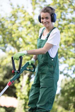 man mows the lawn grass with a lawn mowerの写真素材