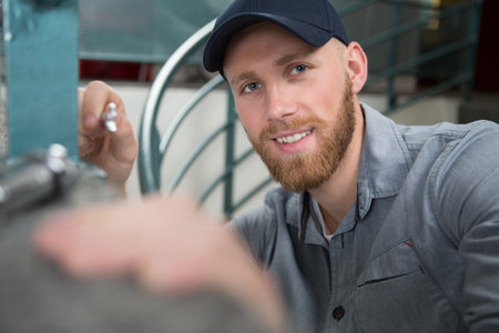 happy young man with toolの写真素材