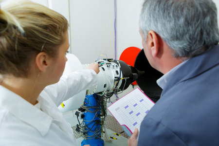 woman and man engineers testing circuit board