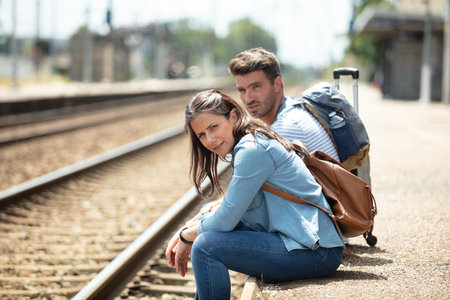 couple waiting on a railway platformの写真素材