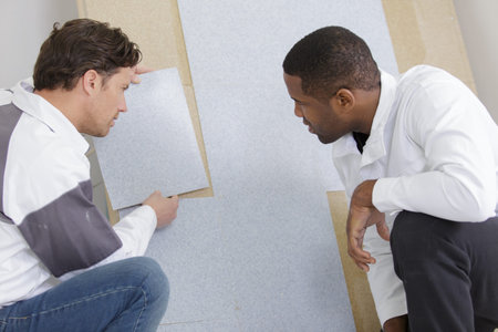 two workers checking something on the wall