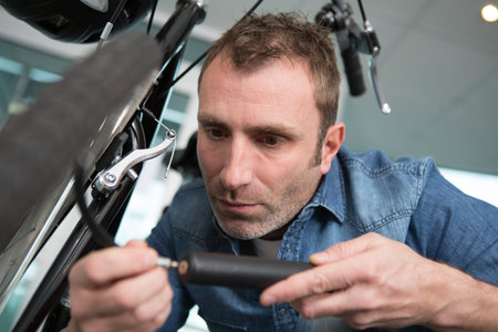 man pumping up a bike
