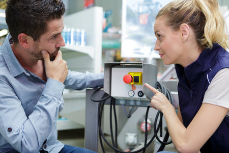 portrait of female operative operating machine in factoryの写真素材