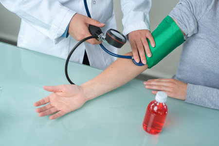 medical worker taking patients blood pressureの写真素材