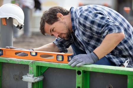 worker using spirit level on wallの写真素材